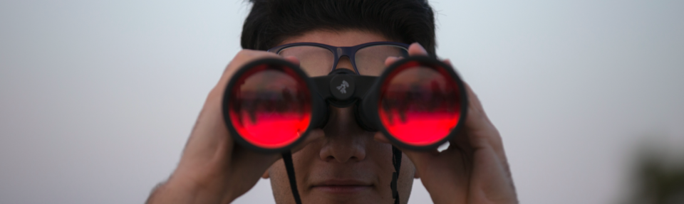 Person looking into binoculars